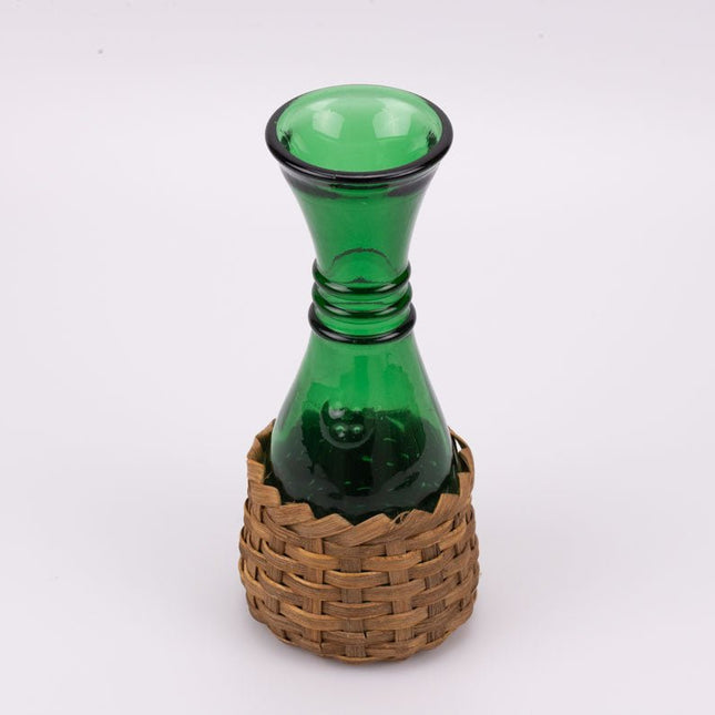 Green glass carafe and woven wicker base