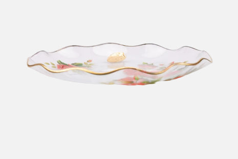 Plat en verre transparent au bord doré et motifs fleuris rouges