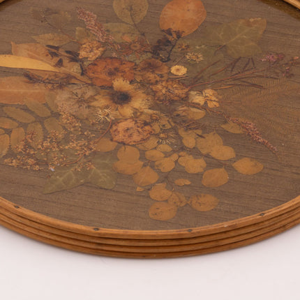 Plateau vintage rond à anses en rotin avec un fond en fleurs séchées