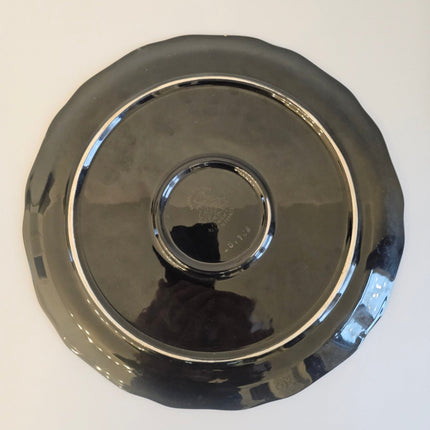 Plat en porcelaine désigné Valenti pour Longwy noir et à motifs fleuris